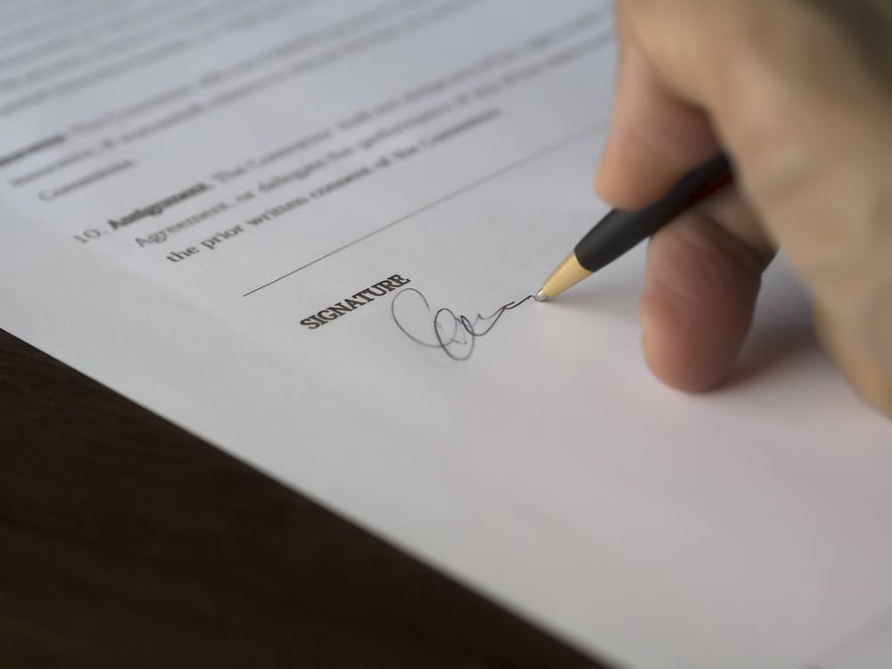A person signing on a document