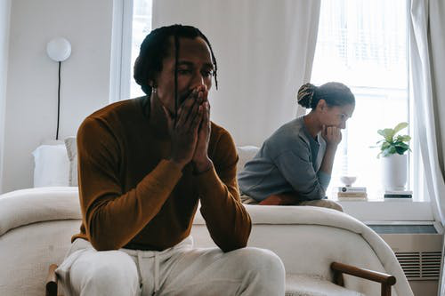 Upset couple sitting in a room