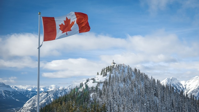 A Canadian flag attached to a pole