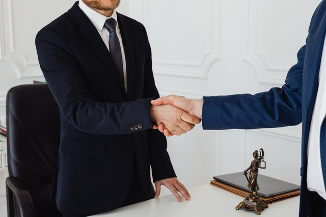 A personal injury lawyer shaking hands with a client