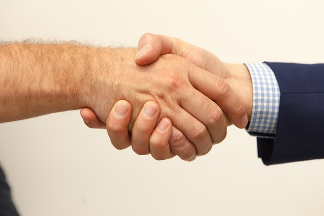 An individual shaking hands with a lawyer