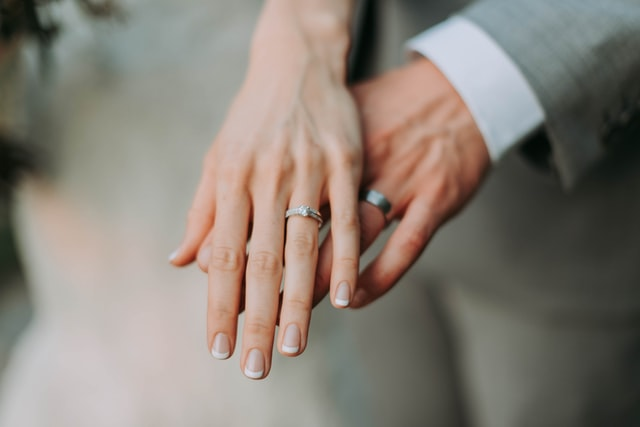 A couple showing their marriage rings