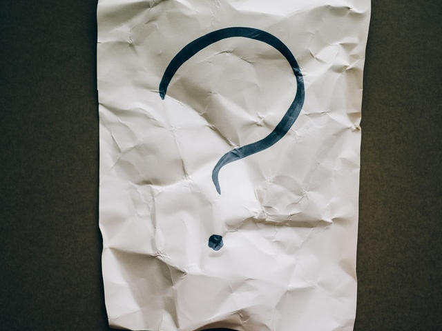 A question mark on a paper
