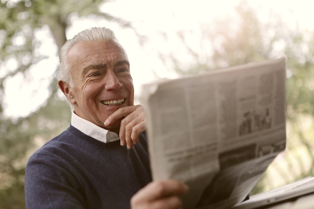A senior person reading newspaper