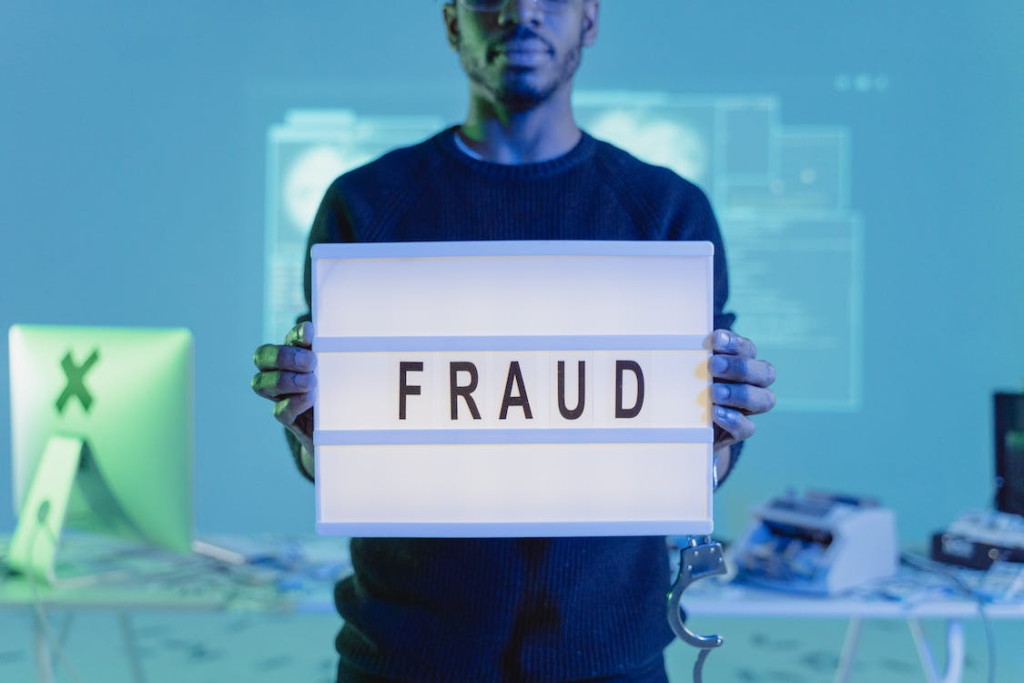 Person holding a board saying fraud