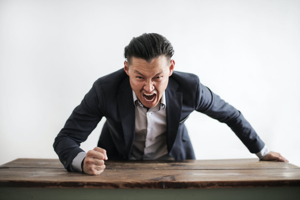 An angry person banging the table