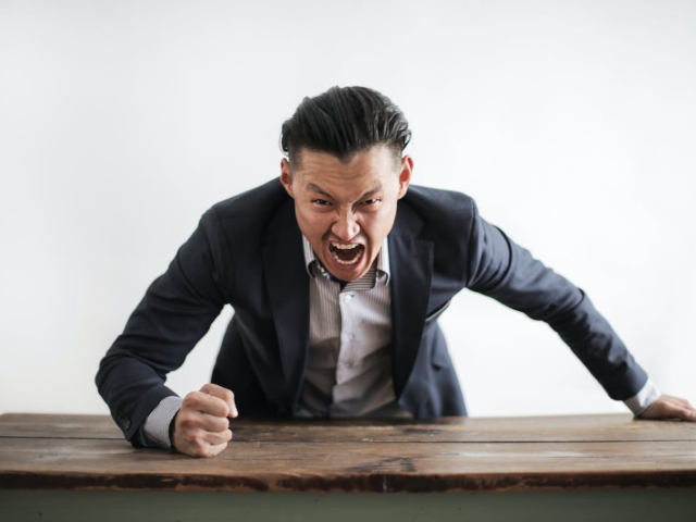 An angry person banging the table