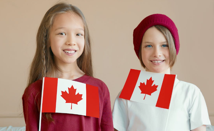 Children holding Canadian flags. 