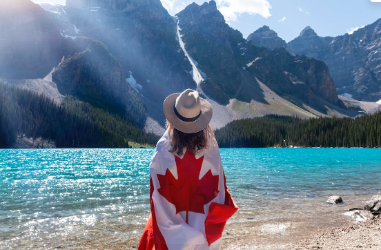 Woman wrapped in Canadian flag. 