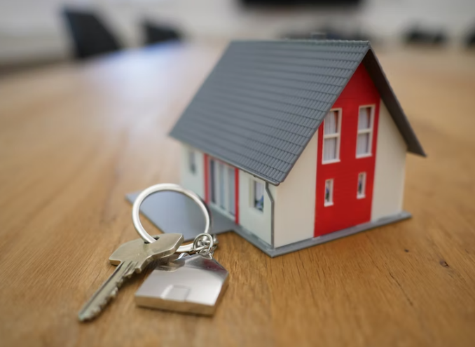 Keys and a miniature model of a house. 