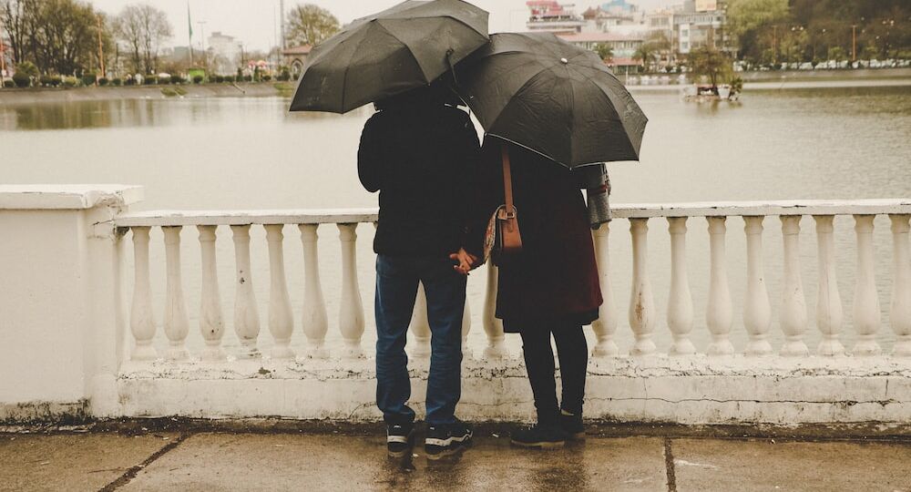 A couple standing in the rain