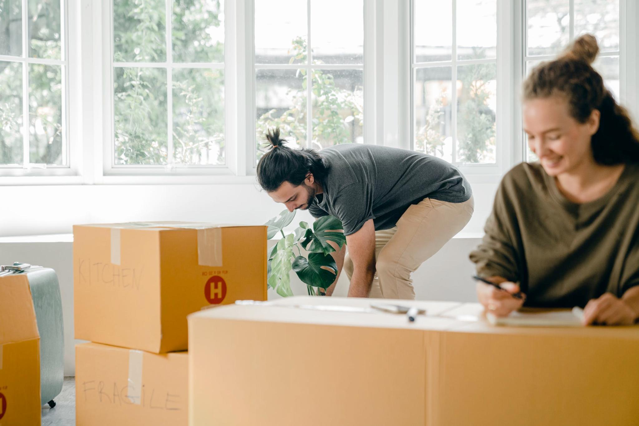 An image of a couple unpacking boxes at home