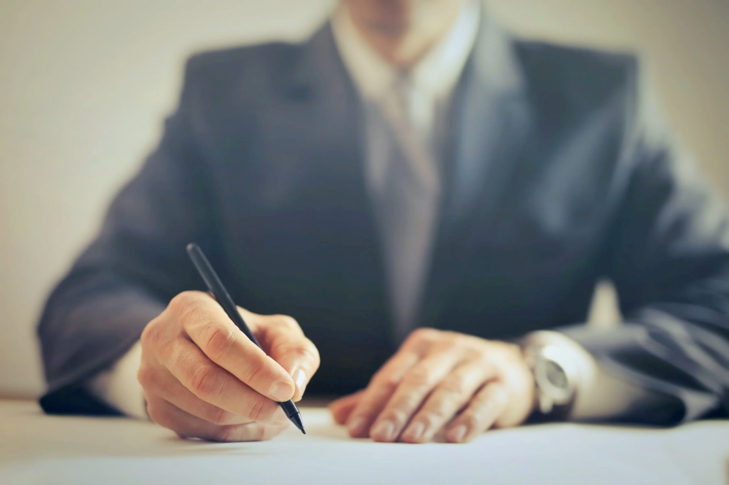 An image of a lawyer signing a contract 