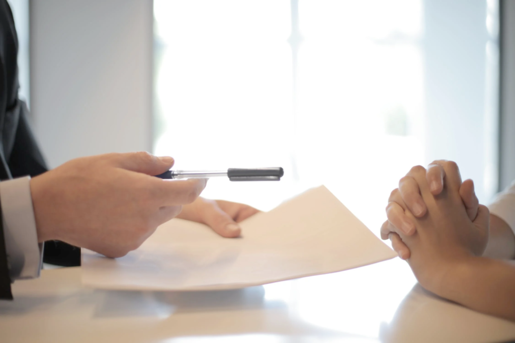 An image of a person asking someone to sign the contract