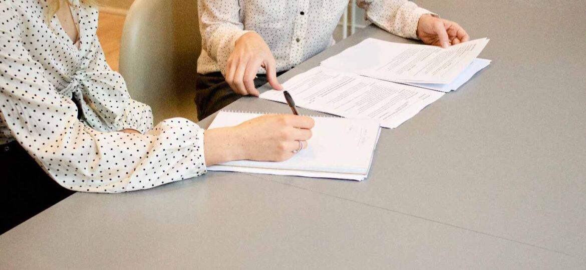 Women signing contracts