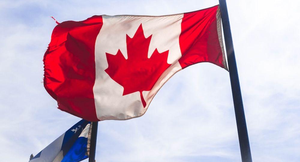 Canadian flag hoisted in the sky