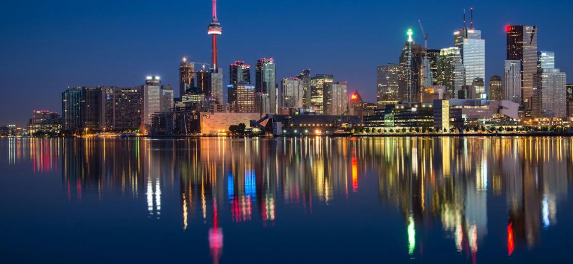 Illuminated Canada skyline at night with city lights reflecting on the water