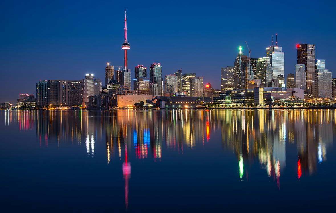 Illuminated Canada skyline at night with city lights reflecting on the water