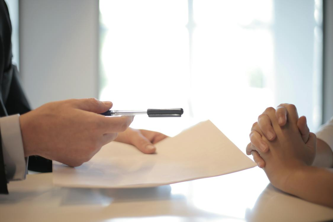 A person handing over a document