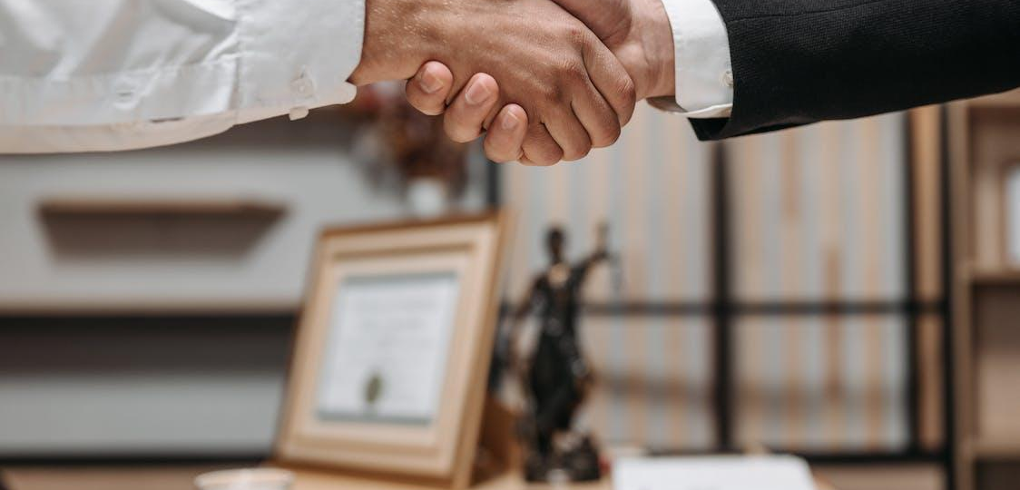 A lawyer and client shaking hands